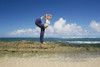 A Young Woman Does A Yoga Pose On A Rock Wall At The Water's Edge; Kauai, Hawaii, United States Of America Poster Print by Kicka Witte / Design Pics - Item # VARDPI2386206