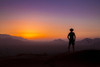 Silhouette of a man wearing a cowboy hat stands looking out at the glowing landscape and sky at sunset; Sossusvlei, Hardap Region, Namibia Poster Print by Aaron Von Hagen / Design Pics - Item # VARDPI12516868