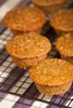 Zucchini muffins cooling on a wire rack above a striped tea towel Poster Print by Janet Horton (18 x 24) # US48JHO1163