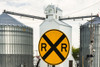 Nebraska, Blair, Washington County. Grain silo and equipment on Front Street, RR crossing sign. Poster Print by Alison Jones - Item # VARPDDUS28AJN0025