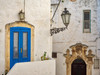 Italy, Puglia, Brindisi, Itria Valley, Ostuni Blue door and ornate carvings surround another doorway Poster Print by Julie Eggers (24 x 18) # EU16JEG0694