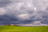 Italy, Tuscany, Val d'Orcia Farmhouse and storm clouds at sunset Credit as: Jim Nilsen / Jaynes Gallery Poster Print by Jaynes Gallery (24 x 18) # EU16BJY0470