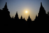 Silhouetted Buddhist temple at sunset; Bagan, Mandalay Region, Myanmar Poster Print by Stuart Corlett (19 x 12) # 12574226