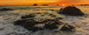 Glowing orange sunset over the Pacific Ocean as viewed over the rock formations from the Oregon coast; Oregon, United States of America Poster Print by The Nature Collection (22 x 9) # 12574038