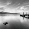 Pier on still lake by Assaf Frank (12 x 12)