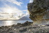 Rock face of sea cliff with honeycomb weathering and sun shining over Loch Scavaig on the Isle of Skye in Scotland, United Kingdom Poster Print by Raimund Linke (20 x 13)