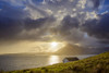 Rooftop of a house along the Scottish coast with sun shining through the dramatic clouds over Loch Scavaig on the Isle of Skye in Scotland, United Kingdom Poster Print by Raimund Linke (17 x 11)