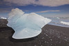 An iceberg beached after coming from the Vatnajokull icecap, Iceland.; Jokulsarlon, Vatnajokull icecap, Iceland. Poster Print by Nigel Hicks (18 x 12)