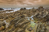 Jagged rock formations on the rocky shore at Cape Agulhas in Agulhas National Park; Western Cape, South Africa Poster Print by Alberto Biscaro (20 x 13)