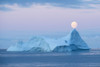 Full moon sets over an iceberg in the Gerlache Strait off the coast of the Antarctic peninsula; Antarctica Poster Print by Jeff Mauritzen (17 x 11)
