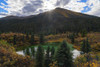 Sunburst over the mountains and reflected in a small pond along the South Canol Road on a beautiful Yukon autumn day; Yukon, Canada Poster Print by Robert Postma (18 x 12)