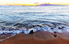 Silhouetted sailboats moored in the tranquil water off the shore at sunset, with a view of the Island of Lanai from a beach at Lahaina; Lahaina, Maui, Hawaii, United States of America Poster Print by LJM Photo (19 x 12)