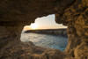 Looking out of cave at sunset near Ayia Napa; Cyprus Poster Print by Ian Cumming (20 x 13)