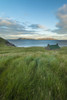 Dibidil Bothy at dusk with the Isle of Eigg in the background, Rum; Scotland, United Kingdom Poster Print by Ian Cumming (13 x 20)