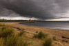 Herd Groyne Lighthouse with storm clouds overhead, and Tyne South Pier Lighthouse in the distance; South Shields, Tyne and Wear, England Poster Print by John Short (19 x 12)