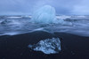 Chunks Of Ice Get Pounded By The Ocean Surf Near The Glacial Lagoon Jokulsarlon; Iceland Poster Print by Robert Postma (17 x 11)