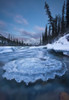 Sunset Over Ice-Covered Rock In Wheaton River; Yukon Canada Poster Print by Robert Postma (12 x 18)