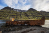 Old Shipwreck Along The Water In Mjoifjordur, East Iceland; Iceland Poster Print by Robert Postma (19 x 12)