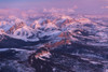 Pink light cast on the snow-covered Front Range of the Rocky Mountains in Montana, USA; Montana, United States of America Poster Print by Michael Melford (17 x 11)