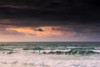 A spectacular sunset as a lone surfer rides a wave at Fistral Beach in Newquay in Cornwall. Poster Print by Loop Images Ltd. (17 x 11)