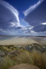 View of the sandy tidal estuary of the Afon Glaswyn looking towards Tremadog Bay with the building known as the Powder House in the far distance. Poster Print by Loop Images Ltd. (12 x 18)