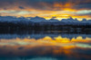 Sunrise on a late autumn, early winter day reflecting on Lake Spenard, with float planes in the shadows, and snow-covered Chugach Mountains in the background, Anchorage, Alaska, USA; Anchorage, Alaska, United States of America Poster Print by Amber