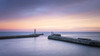 Dawn view of the entrance to Whitby harbour. Poster Print by Loop Images Ltd. (19 x 11)