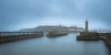 Entrance to the harbour at  Whitby looking back towards the town. Poster Print by Loop Images Ltd. (20 x 10)