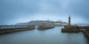 Entrance to the harbour at  Whitby looking back towards the town. Poster Print by Loop Images Ltd. (20 x 10)