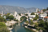 Mostar and the Stari Most Old Bridge spanning the Neretva River. Poster Print by Loop Images Ltd. (18 x 12)