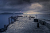 The harbour wall at Lyme Regis. Poster Print by Loop Images Ltd. (17 x 11)