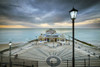 The street lights start to come on as the sun sets at Cromer pier. Poster Print by Loop Images Ltd. (20 x 13)
