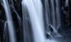 Close-up of a series of waterfalls, the soft blur of flowing water over black rock; Iceland Poster Print by Robert Postma (21 x 12)