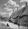Historic image in black and white of thatched cottages and a church in a village in England, circa 1890; Swalcliffe, Oxfordshire, England Poster Print by John Short (15 x 16)