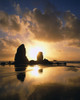 Silhouetted Haystack Rock and other sea stacks in the pacific ocean at Cannon Beach at sunset, Oregon coast; Cannon Beach, Oregon, United States of America Poster Print by Craig Tuttle (13 x 17)