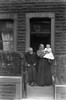 Glass Negative circa 1900.Victorian.Social History. an old lady and gentleman at the door holding a baby Poster Print by John Short (13 x 20)