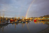 Rainbow in morning light over Yaquina Bay Bridge and fishing boats in the harbour; Newport, Oregon, United States of America Poster Print by Craig Tuttle (17 x 11)