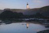 Yaquina Head Light reflected in a tide pool along the Oregon coast at sunrise, Yaquina Bay State Park; Oregon, United States of America Poster Print by Craig Tuttle (17 x 11)