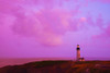 Dramatic pink sky at sunrise over Yaquina Head Light on the Oregon Coast; Newport, Oregon, United States of America Poster Print by Craig Tuttle (17 x 11)