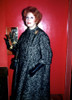 Arlene Dahl full standing shot wearing a black and white coat and black leather gloves. Photo: Oscar Abolafia (ARLENEDAHL4) Poster
