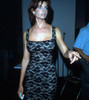 Actress model Joan Severance is wearing a black lace cocktail dress, pointing to someome at an event, 1980s. Photo: Oscar Abolafia (joanseverance001) Poster