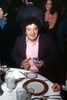 Actor George Savalas, brother of Telly Savalas, both actors on 1970s Police drama, showing his police badge sitting at table at event, 1970s. Photo: Oscar Abolafia (georgesavalas002) Poster