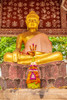 Laos- Luang Prabang. Golden Buddha statue and altar. Poster Print - Tom Haseltine