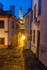 Narrow cobblestone streets at dusk with Castle Tower in historic Cesky Krumlov-Czech Republic. Poster Print - Chuck Haney