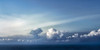 String of Clouds Over the Sea Poster Print - Don Schwartz