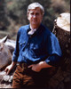 Leslie Nielsen In Denim Shirt Leaning On Tree Trunk Photo Print - Item # MVM56243