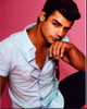 Garrett Clayton Holding Sunglasses Pink Background Photo Print - Item # MVM59756