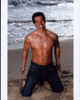 Antonio Sab�to Jr. Shirtless Kneeling On Beach Photo Print - Item # MVM59658