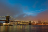 Manhattan skyline and the Brooklyn bridge in the mist at dusk Poster Print - Sergio Pitamitz