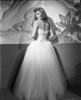 Jean Arthur looking over her shoulder wearing a ball gown Photo Print - Item # VARCEL680802